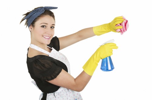 Spot cleaning a fabric couch stain with a microfiber cloth
